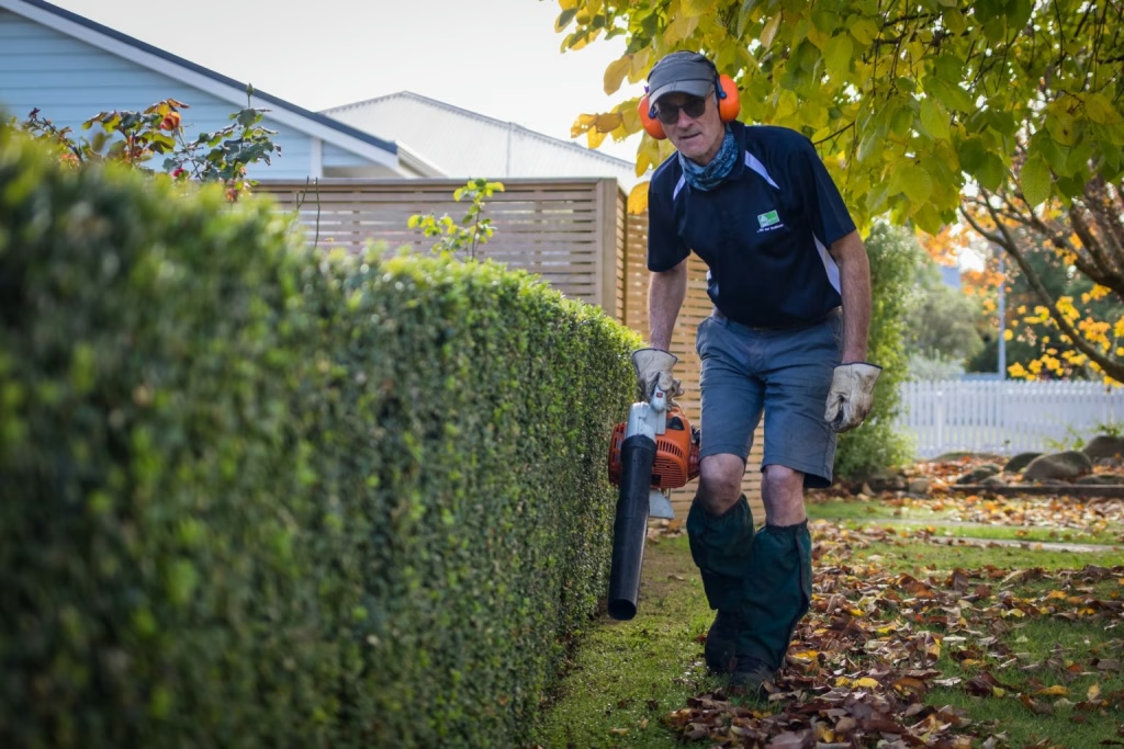 Mr Green Home Services crew doing hedge and garden work