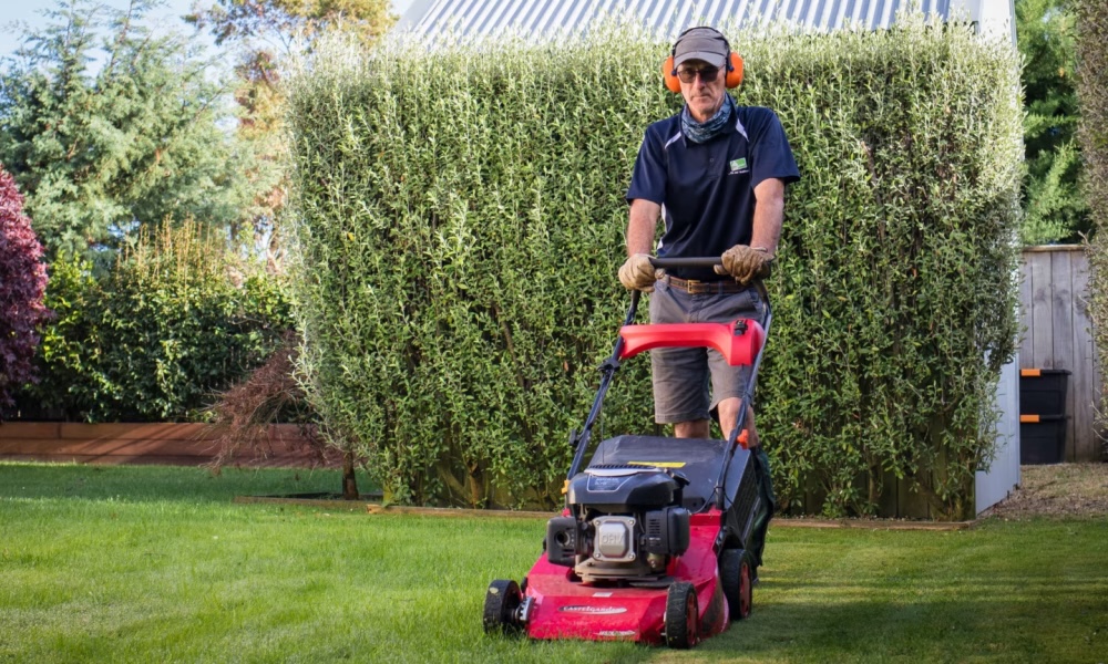 Mr Green Home Services mowing a lawn